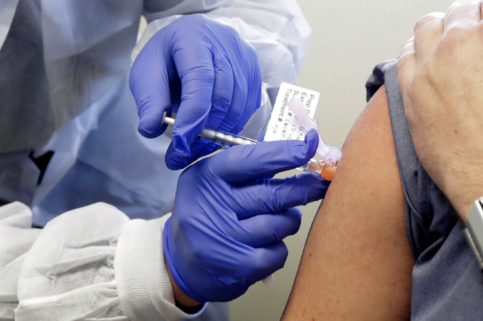THE R.I. DEPARTMENT of Health said that due to the mild side effects caused by the COVID-19 vaccine, staff members of long-term care facilities should be vaccinated in phases to prevent multiple staff members from not feeling well at once. / AP PHOTO/TED S. WARREN