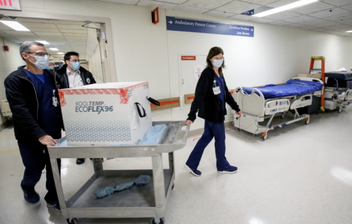 MODERNA INC Vaccine arrived at Rhode Island Hospital Dec. 22, which will also help prevent the spread of a new COVID-19 variant that was recently identified in the U.S. [Above] Richard Emery, Lifespan's pharmacy supervisor and Karen Nolan, Lifespan's pharmacy manager. / LIFESPAN CORP./ BILL MURPHY