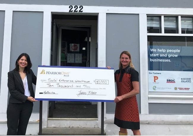 HARBORONE BANK recently donated $100,000 to Social Enterprise Greenhouse for its new business resource center. Pictured are Claudia Cardozo, left, HarborOne community development manager and SEG board member, and Kelly Ramirez, CEO of SEG. / COURTESY HARBORONE BANK