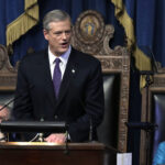 MASS. GOV. CHARLIE BAKER announced that the state is easing some of its COVID-19 restrictions by increasing the capacity limits on businesses to 40%. / AP FILE PHOTO/STEVEN SENNE