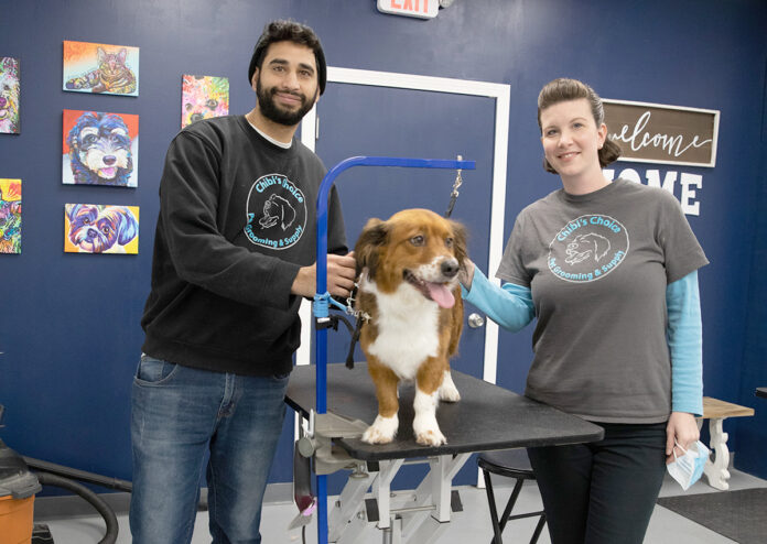 POOCH PASSION: Former graphic designer Aldo Abreu, left, now uses his expertise to groom pets after opening Chibi’s Choice Pet Grooming & Supply in East Providence with his wife, Megan, right. / PBN PHOTO/RUPERT WHITELEY