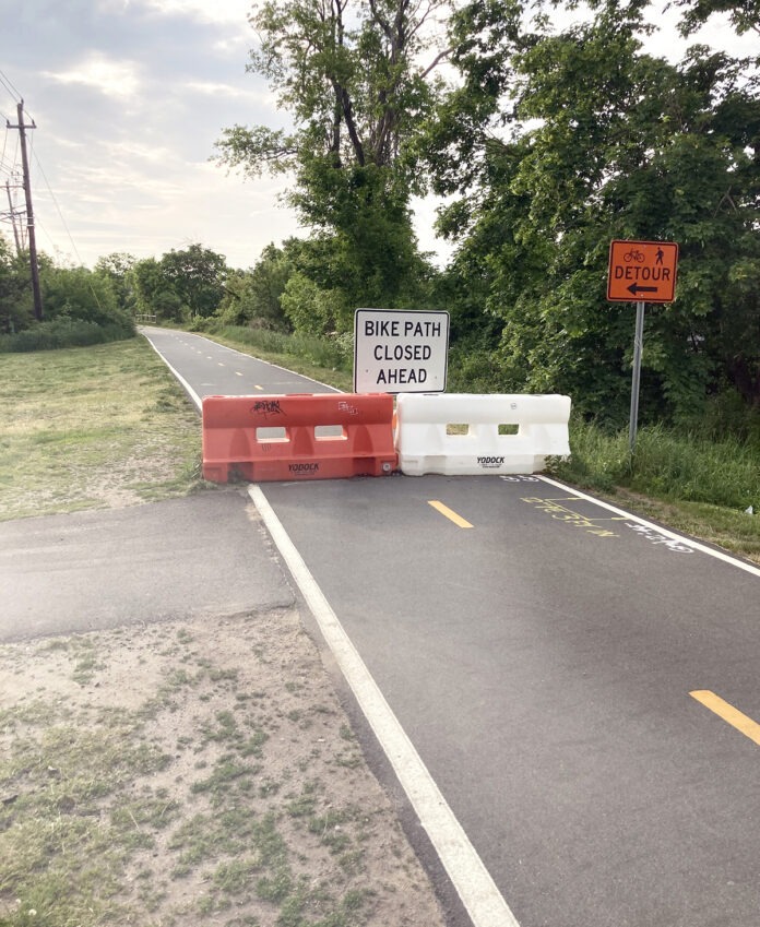 FOR 18 MONTHS, signs in Warren and Barrington have detoured cyclists and walkers off the East Bay Bike Path because of two unsafe bridges. Grow Smart Rhode Island says it’s an indication that the R.I. Department of Transportation has put a low priority on “active transportation” infrastructure. / PBN PHOTO/WILLIAM HAMILTON