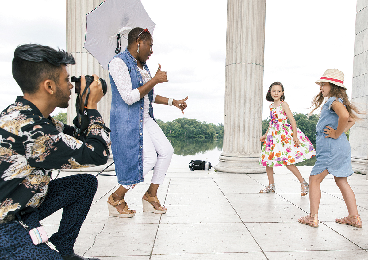ON LOCATION: Donahue Models & Talent LLC owner Yemi Sekoni directs, from left, Ruby Boesch and Molly McBride during a recent photo shoot at the Temple to Music in Roger Williams Park in Providence. The photographer is Yan La Mort. / PBN FILE PHOTO/RUPERT WHITELEY