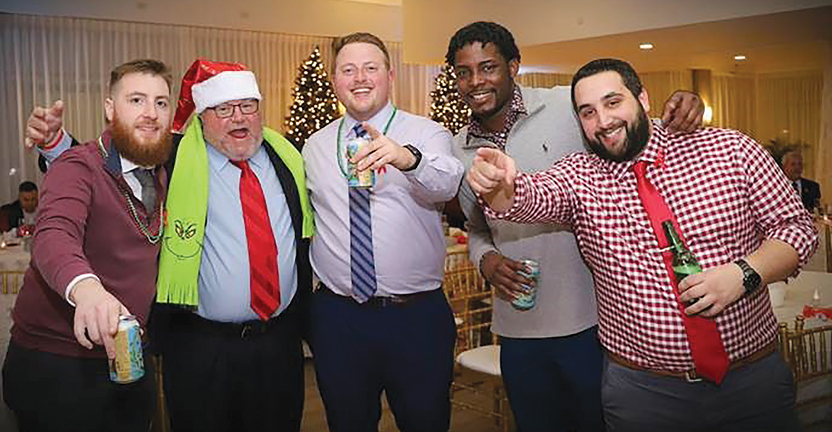 HOLIDAY CHEER: Rite-Solutions Inc. employees get into the spirit at a recent holiday company party. / COURTESY RITE-SOLUTIONS INC.