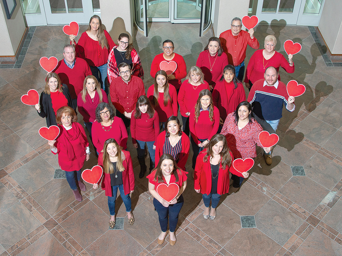 HAVING A HEART: Amica Mutual Insurance Co. employees take part in the American Heart Association’s “Wear Red Day” to raise awareness of cardiovascular disease. / COURTESY AMICA MUTUAL INSURANCE CO.
