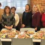 NICE TREATS: Sansiveri, Kimball & Co. LLP employees gather at a recent cookie swap. / COURTESY SANSIVERI, KIMBALL & CO. LLP