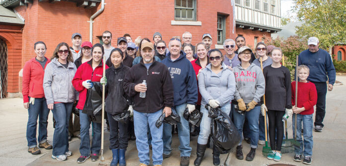 NICE AND TIDY: Rhode Island Foundation employees and their families perform a community cleanup. / COURTESY RHODE ISLAND FOUNDATION
