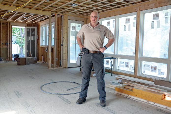 WASTE NOT, WANT NOT: David A. Caldwell Jr., vice president of North Kingstown custom-homebuilding company Caldwell & Johnson Inc., at the construction site for a Jamestown home that will be capable of net-zero energy use.  / PBN PHOTO/ELIZABETH GRAHAM