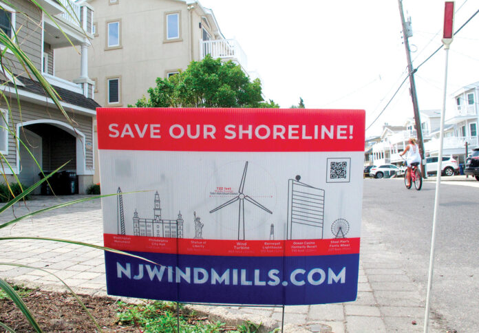 WIND RESISTANCE: A lawn sign in Ocean City, N.J., opposing offshore wind turbines compares the size of the proposed turbines along the New Jersey coast with other structures such as the Washington Monument and the Statue of Liberty. / AP PHOTO/WAYNE PARRY