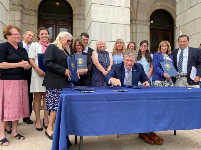 GOV. DANIEL J. MCKEE on Wednesday signed a host of bills aimed at advancing women's health and combating gender discrimination. /COURTESY RI GOVERNOR'S OFFICE
