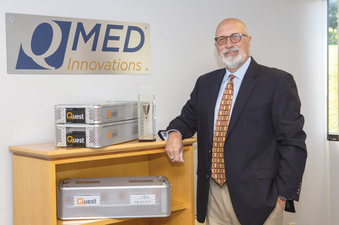 KEEPING TABS: Victor Nunes, founder and principal owner of QMed Innovations Inc. in Middletown, showcases the company’s Quest tracking product, which uses internet-connected technology to provide location data so manufacturers can keep track of their surgical kits that are used in orthopedic procedures. / PBN PHOTO/KATE WHITNEY LUCEY