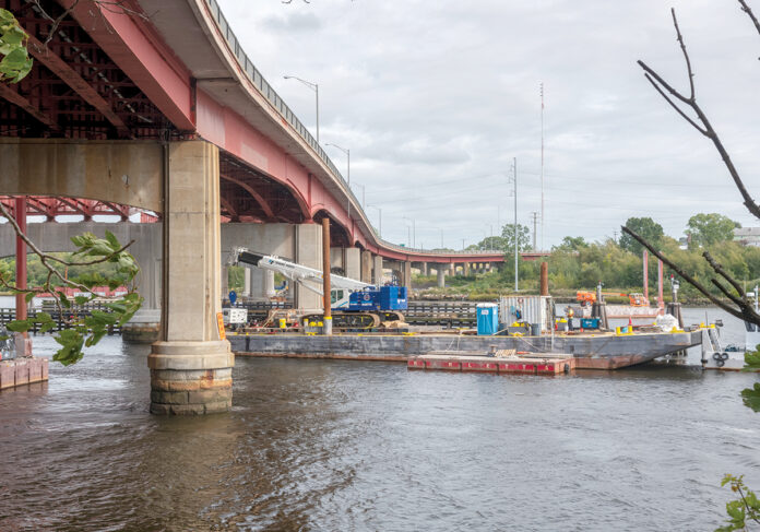 BELOW DECK: A barge is being used under the Henderson Bridge to assist workers removing some of the bridge decking as part of the $84.4 million overhaul of the 52-year-old span across the Seekonk River.  / PBN PHOTO/MICHAEL SALERNO