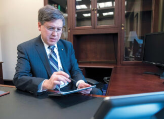 Mobile banking making leaps ahead SITE VISIT: Mark K. W. Gim, president and chief operating officer of Westerly-based Washington Trust Bancorp., demonstrates the bank’s website technology on his iPad in 2018. But the regional bank didn’t abandon its brick-and-mortar strategy, opening several new branches in recent years. / PBN FILE PHOTO/MICHAEL SALERNO