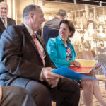 MOVING ON: Pawtucket Mayor Donald R. Grebien talks with then-Gov. Gina M. Raimondo at an August 2018 press conference at Slater Mill to discuss the Pawtucket Red Sox’ decision to move to Worcester, Mass. / PBN FILE PHOTO/MICHAEL SALERNO