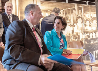 Faces change, differences remain MOVING ON: Pawtucket Mayor Donald R. Grebien talks with then-Gov. Gina M. Raimondo at an August 2018 press conference at Slater Mill to discuss the Pawtucket Red Sox’ decision to move to Worcester, Mass. / PBN FILE PHOTO/MICHAEL SALERNO