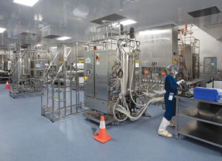 Building on the promise of biotech CLEAN ENVIRONMENT: An Amgen employee works inside the next-generation biomanufacturing plant built in West Greenwich in 2020. / COURTESY AMGEN RHODE ISLAND/AL WEEMS