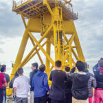FUTURE WORKFORCE? Rhode Island high school students participating in a career pathway program for offshore wind jobs ride in a boat circling a Block Island Wind Farm turbine. /  COURTESY LUCKY DAWG PHOTOGRAPHY/DOUG LEARNED