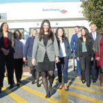 A BIG BOOST: Bank of America Corp.’s diversity recruitment efforts include hiring 10,000 people companywide from low- to moderate-income communities. Among the bank’s local diversity and inclusion leaders walking from its corporate facility in Lincoln are Kate DeTora, vice president of financial solutions, center; Phoebe E. Peck, vice president of financial solutions, far left; and Eliza Sharrah, fraud communications strategy program manager, far right. / PBN PHOTO/ELIZABETH GRAHAM