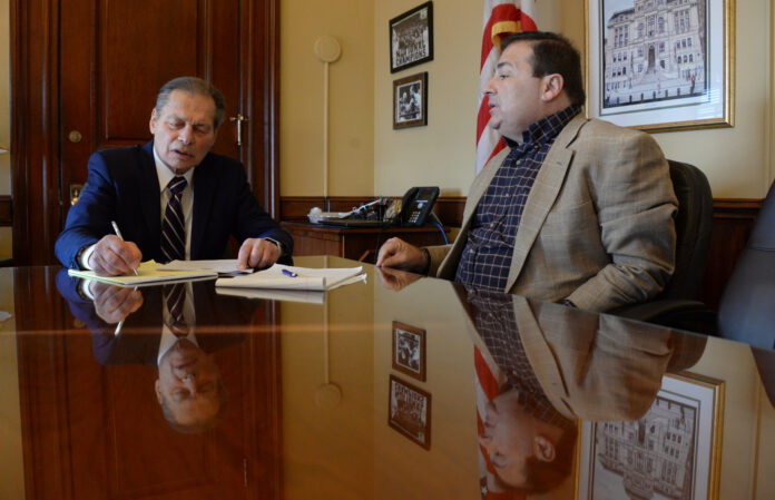 Ruggerio & Shekarchi (credit Liz Graham) RHODE ISLAND SENATE President Dominick J. Ruggerio, left, and House Speaker K. Joseph Shekarchi talk at the Statehouse earlier this month. / PBN PHOTO/ELIZABETH GRAHAM