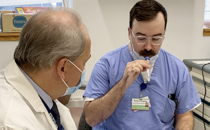 the-bubbler-03 SAMUEL KAPLAN, right, clinical research assistant for Lifespan Corp., tests the Bubbler while Dr. Gregory Jay, a professor in the Department of Emergency Medicine and Division of Engineering at Brown University, looks on. COURTESY LIFESPAN CORP.