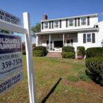 THE MEDIAN price of single-family homes sold in Rhode Island climbed in January by 10.8 % from a year ago, while sales increased after falling in the last six months of 2021, the Rhode Island Association of Realtors said Thursday. / AP FILE PHOTO/STEVEN SENNE