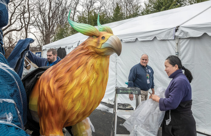 READY FOR TAKEOFF: James Lolio, left, event manager for the Roger Williams Park Zoo; Ronald Patalano, deputy director of zoo operations; and Do Bao, of Hannart Culture, prepare one of the displays for the Asian Lantern Spectacular set to open at the zoo on April 13. / PBN PHOTO/MICHAEL SALERNO