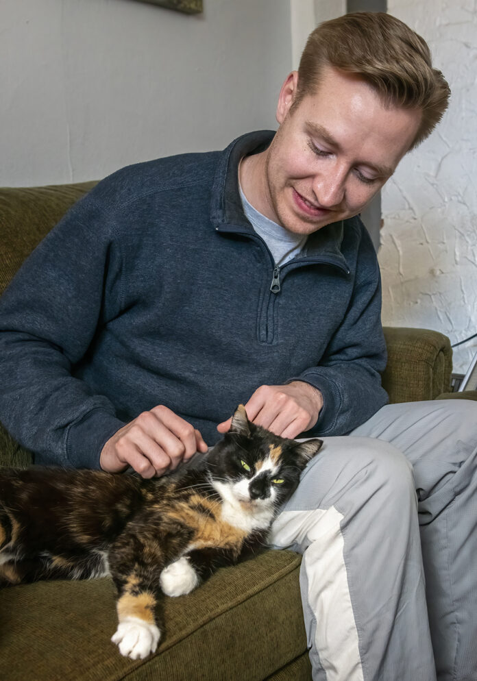 IN THE FAMILY: Bradly VanDerStad says he wanted to avoid having to make a difficult financial choice when it came to his cat, Sylvia, so he purchased health insurance for her. / PBN PHOTO/MICHAEL SALERNO IN THE FAMILY: Bradly VanDerStad says he wanted to avoid having to make a difficult financial choice when it came to his cat, Sylvia, so he purchased health insurance for her. / PBN PHOTO/MICHAEL SALERNO