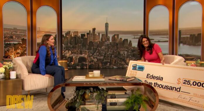NAVYN SALEM, right, founder and CEO of North Kingstown-based food manufacturer Edesia Inc., reacts to receiving a $25,000 donation on 'The Drew Barrymore Show' that aired March 23 from Perdue Farms. Barrymore then matched the donation, giving Edesia $50,000. / COURTESY YOUTUBE.COM