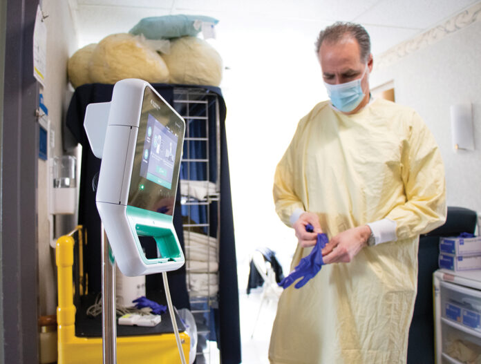 HELPING HAND: John Schreiber is one of about 50 travel nurses who have been hired temporarily to fill open positions at Kent County Memorial Hospital in Warwick. The use of travel nurses at hospitals has increased because of a labor shortage. / COURTESY CARE NEW ENGLAND HEALTH SYSTEM/RYAN PICKERING