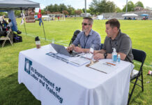 RELIABLE RESOURCE: Jeremy Tolleson, left, veteran program manager for the R.I. Department of Labor and Training, at a Veterans Expo event at Pierce Memorial Stadium in East Providence, with Roger Richards, veterans representative. As more employees are quitting or not showing up to work, companies are turning to veterans to fill their workforces. / PBN PHOTO/MICHAEL SALERNO