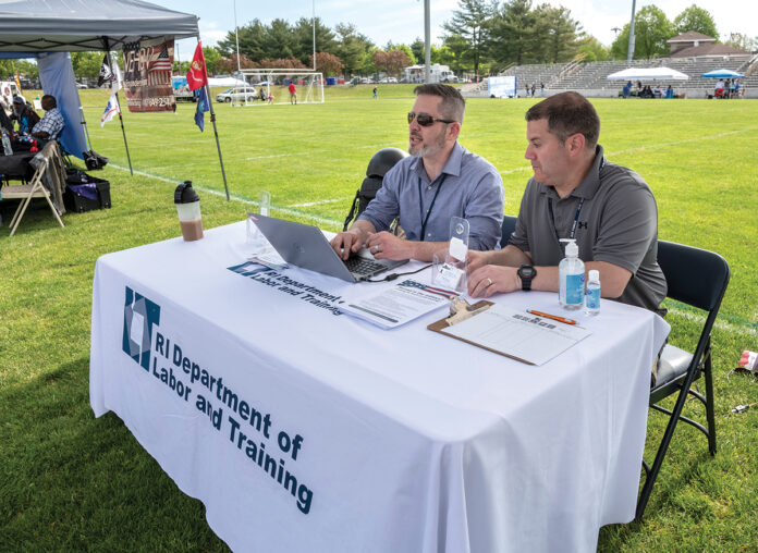 RELIABLE RESOURCE: Jeremy Tolleson, left, veteran program manager for the R.I. Department of Labor and Training, at a Veterans Expo event at Pierce Memorial Stadium in East Providence, with Roger Richards, veterans representative. As more employees are quitting or not showing up to work, companies are turning to veterans to fill their workforces. / PBN PHOTO/MICHAEL SALERNO