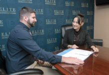 TITLE TALK: Diep Nguyen, right, managing member of Elite Title & Closing Services LLC in East Providence, meets with Robert Watson, associate ­attorney. / PBN FILE PHOTO/MICHAEL SALERNO