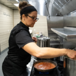 RACHAEL LAPORTE, director of food operations at Town Made LLC, prepares food at the recently opened commercial kitchen in the Wakefield section of South Kingstown. / COURTESY TOWN MADE LLC