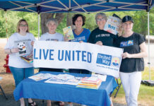United Way of Rhode Island Inc. GOOD READING: United Way of Rhode Island Inc. employees attend a recent outdoor event to promote reading for children. / COURTESY UNITED WAY OF RHODE ISLAND INC.