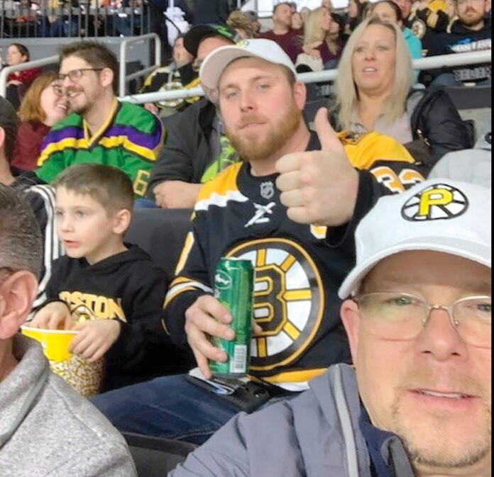 HOCKEY NIGHT: Employees from Connectivity Point Design & Installation LLC take in a Providence Bruins game at the Dunkin’ Donuts Center. / COURTESY CONNECTIVITY POINT DESIGN & INSTALLATION LLC