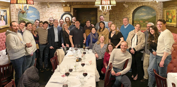DINNER TIME: Employees at DarrowEverett LLP gather for a company dinner. / COURTESY DARROWEVERETT LLP DINNER TIME: Employees at DarrowEverett LLP gather for a company dinner. / COURTESY DARROWEVERETT LLP