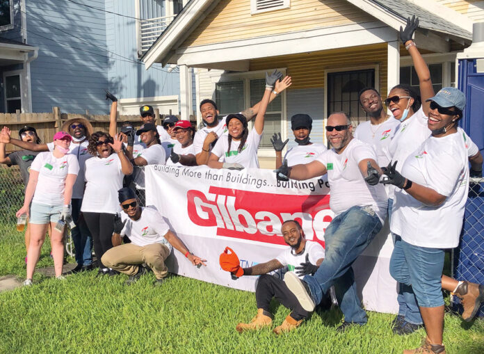 TEAMWORK: Gilbane Building Co. employees partner with nonprofit Rebuilding Together on a community service project. / COURTESY GILBANE BUILDING CO. TEAMWORK: Gilbane Building Co. employees partner with nonprofit Rebuilding Together on a community service project. / COURTESY GILBANE BUILDING CO.