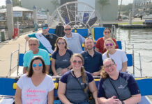 Landings Real Estate Group ON THE WATER: Staffers at Landings Management LLC enjoy a boat ride at a recent company outing. / COURTESY LANDINGS MANAGEMENT LLC