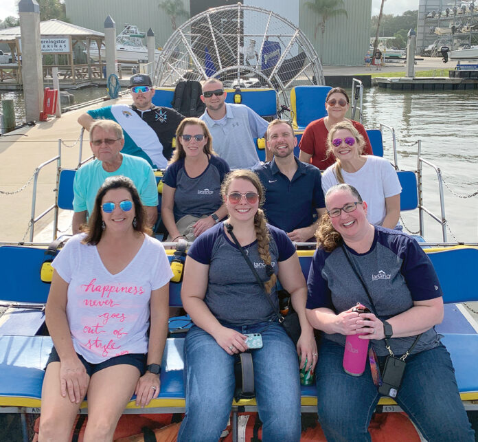 ON THE WATER: Staffers at Landings Management LLC enjoy a boat ride at a recent company outing. / COURTESY LANDINGS MANAGEMENT LLC