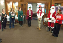 Amica Mutual Insurance Co. GIVING SEASON: Amica Mutual Insurance Co. employees, with an assist from Santa Claus, continue a long tradition of holiday giving with a penny social, which raised over $6,500 to benefit the Alzheimer’s Association. / COURTESY AMICA MUTUAL INSURANCE CO.