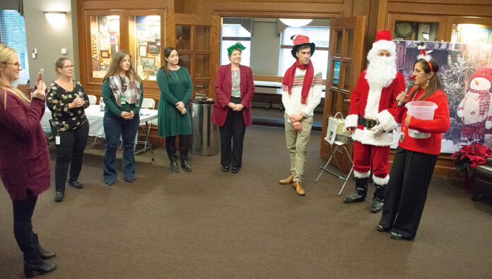 GIVING SEASON: Amica Mutual Insurance Co. employees, with an assist from Santa Claus, continue a long tradition of holiday giving with a penny social, which raised over $6,500 to benefit the Alzheimer’s Association. / COURTESY AMICA MUTUAL INSURANCE CO. GIVING SEASON: Amica Mutual Insurance Co. employees, with an assist from Santa Claus, continue a long tradition of holiday giving with a penny social, which raised over $6,500 to benefit the Alzheimer’s Association. / COURTESY AMICA MUTUAL INSURANCE CO.