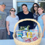 BUILDING BASKETS: Marasco & Nesselbush LLP employees visit the Jonnycake Center of Peace Dale to assemble and distribute Fourth of July baskets. / COURTESY MARASCO & NESSELBUSH LLP