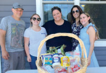 Marasco & Nesselbush LLP BUILDING BASKETS: Marasco & Nesselbush LLP employees visit the Jonnycake Center of Peace Dale to assemble and distribute Fourth of July baskets. / COURTESY MARASCO & NESSELBUSH LLP