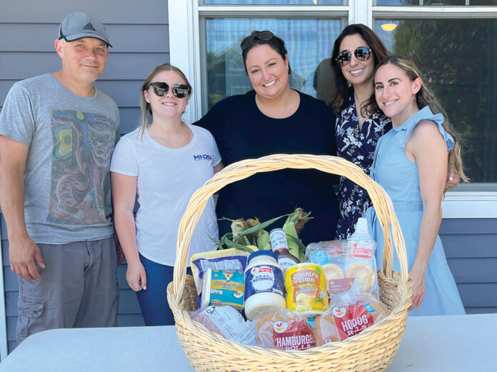 BUILDING BASKETS: Marasco & Nesselbush LLP employees visit the Jonnycake Center of Peace Dale to assemble and distribute Fourth of July baskets. / COURTESY MARASCO & NESSELBUSH LLP BUILDING BASKETS: Marasco & Nesselbush LLP employees visit the Jonnycake Center of Peace Dale to assemble and distribute Fourth of July baskets. / COURTESY MARASCO & NESSELBUSH LLP