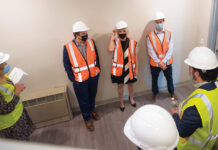 R.I. Housing and Mortgage Finance Corp. SAFETY FIRST: Staffers for R.I. Housing and Mortgage Finance Corp. prep to work at a project site. / COURTESY R.I. HOUSING AND MORTGAGE FINANCE CORP.