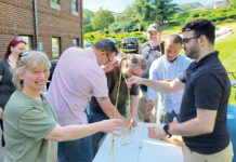 Technology Advisory Group LLC PASTA POWER: Technology Advisory Group LLC employees work on a project in which they construct a tower made of spaghetti.
COURTESY TECHNOLOGY ADVISORY GROUP LLC
