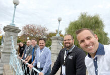 IT Support RI BRIDGE WORK: Members of IT Support RI’s management team gather on a bridge during a recent trip to Boston. / COURTESY IT SUPPORT RI