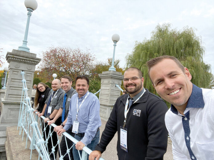 BRIDGE WORK: Members of IT Support RI’s management team gather on a bridge during a recent trip to Boston. / COURTESY IT SUPPORT RI BRIDGE WORK: Members of IT Support RI’s management team gather on a bridge during a recent trip to Boston. / COURTESY IT SUPPORT RI
