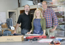 AVTECH Software Inc. STAYING ALERT: AVTECH Software Inc. employees Rick Grundy, Anne Sigourney and Michael Sigourney pose with the company’s Room Alert environment monitor. / COURTESY AVTECH SOFTWARE INC.