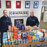 FEEDING THE NEEDY: Compass IT Compliance LLC employees donate food to the Blackstone Valley Emergency Food Center. / COURTESY COMPASS IT COMPLIANCE LLC